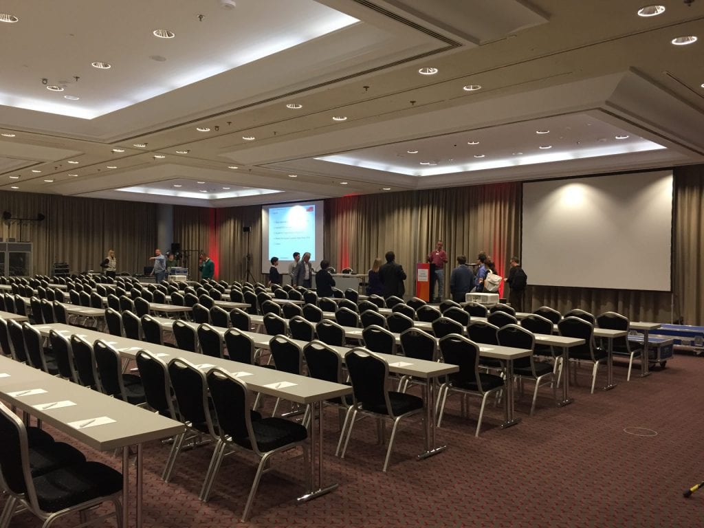 The speakers and presenters visit the stage and stage technology. The grey box at the back left is the interpreter's booth, which housed the two simultaneous interpreters. 